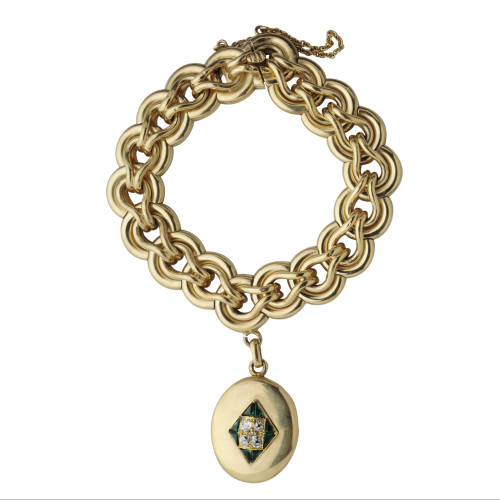 Bracelet constitué d'une large chaine forçat, avec un pendentif circulaire orné de pierres vertes et de brillants contenant une mèche de cheveux sous verre